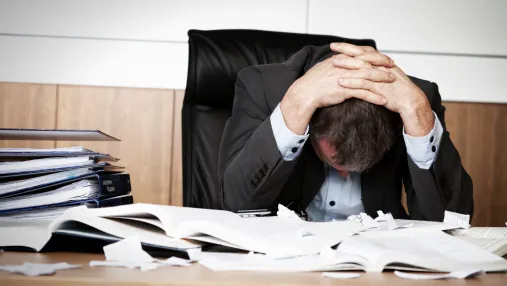 Frustrated office manager overwhelmed with paperwork